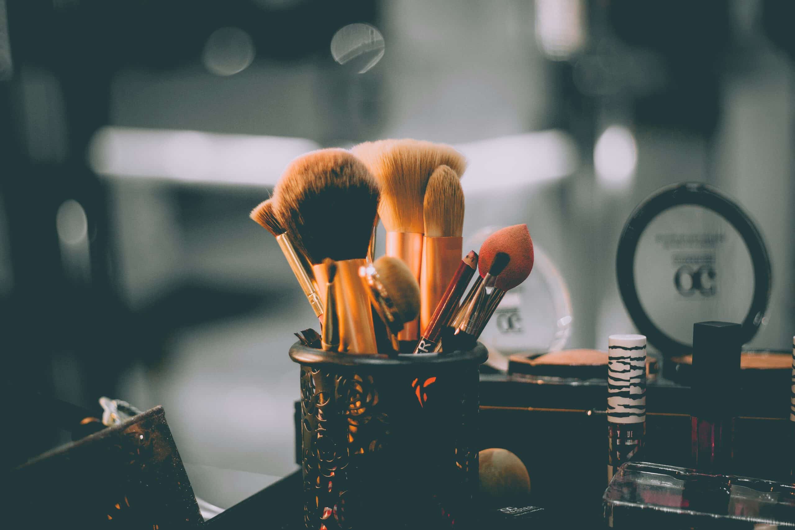 assorted makeup brushes in a container