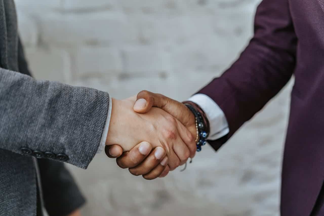 close up shot of two people in a handshake