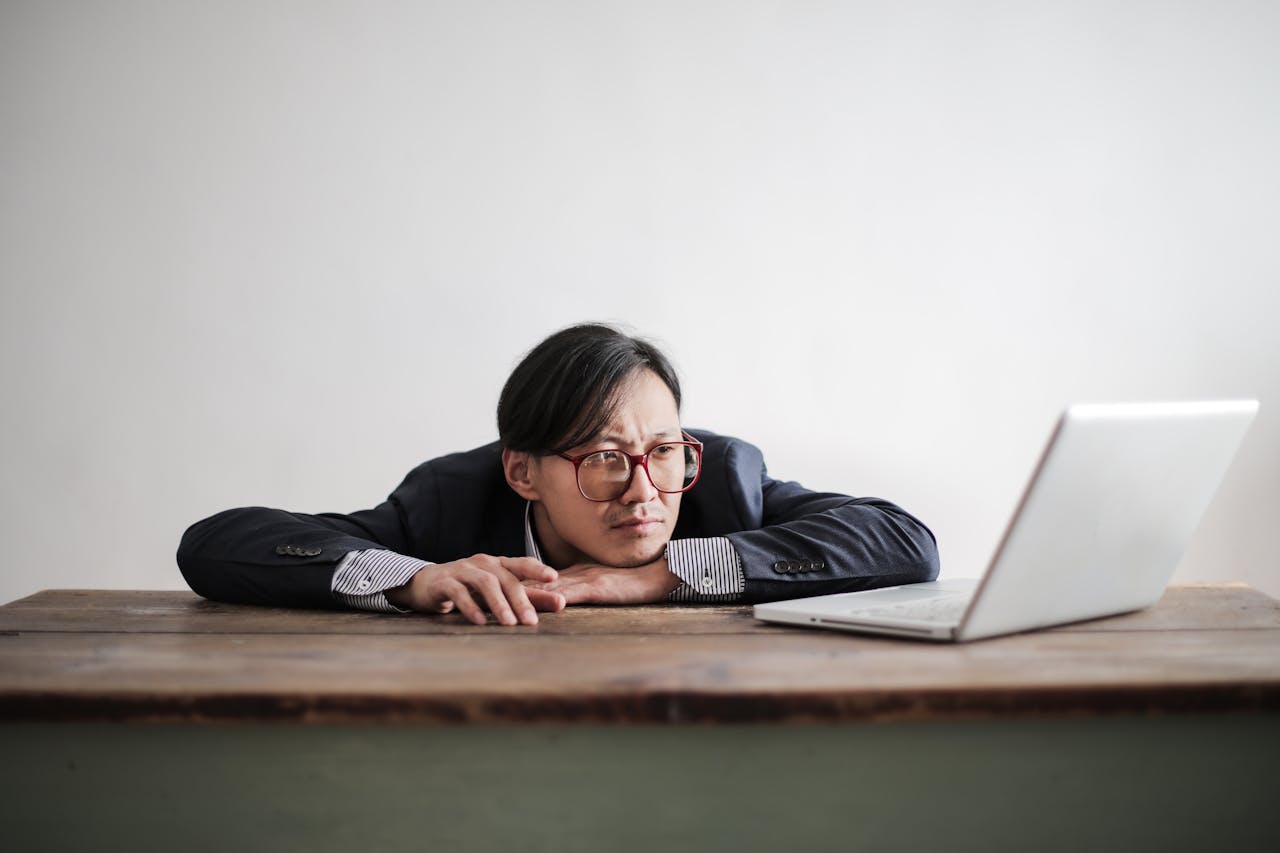 a person looking bored while looking at computer