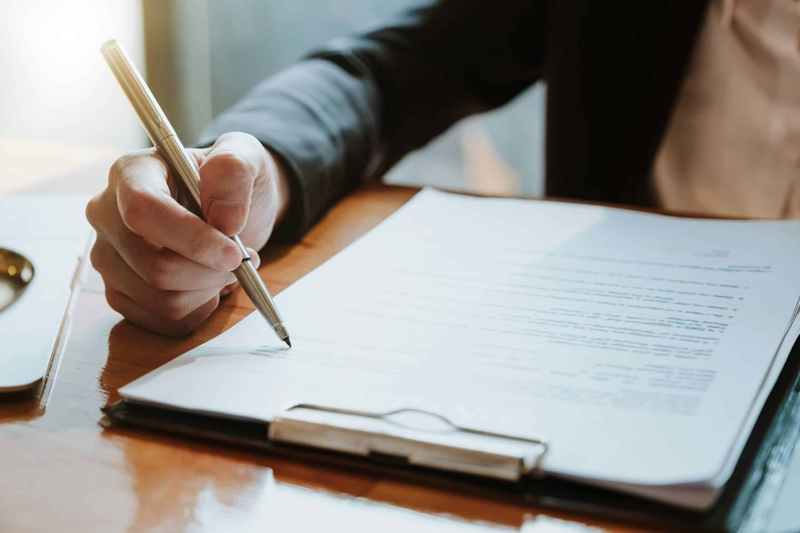 Woman reviewing a contract representing the implications of fixed term contracts